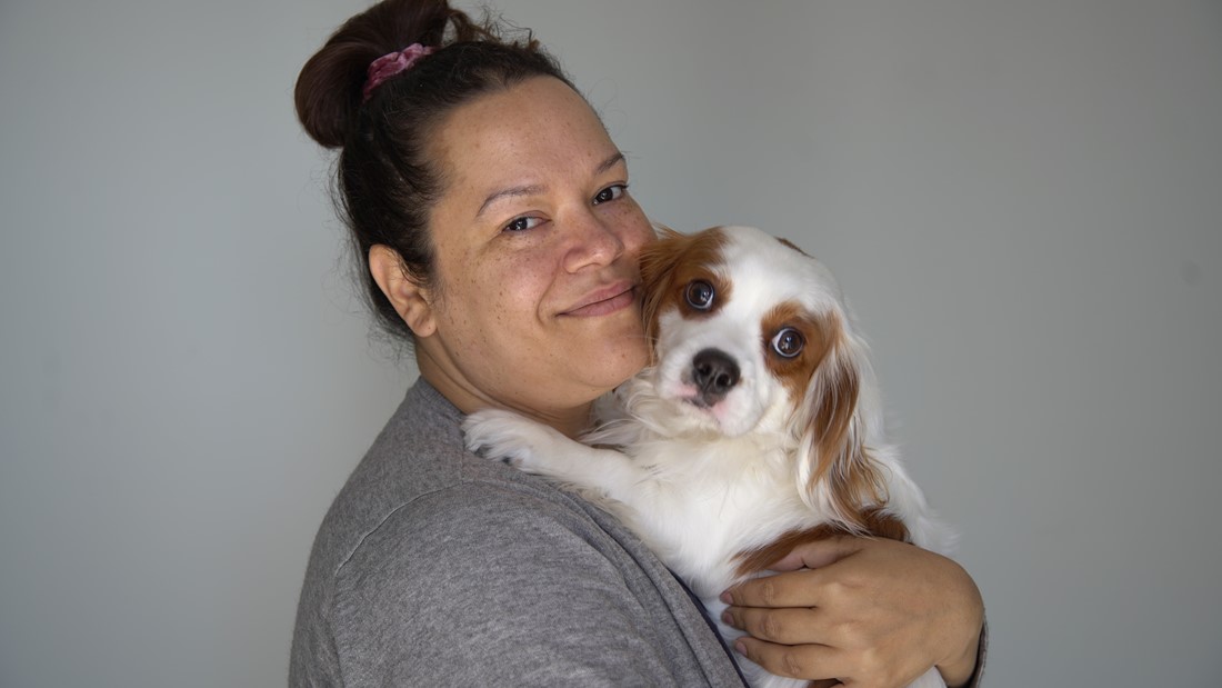 Leilani cuddling her dog